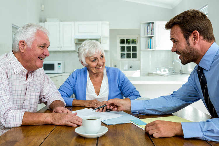 an elderly couple consulting with a younger man