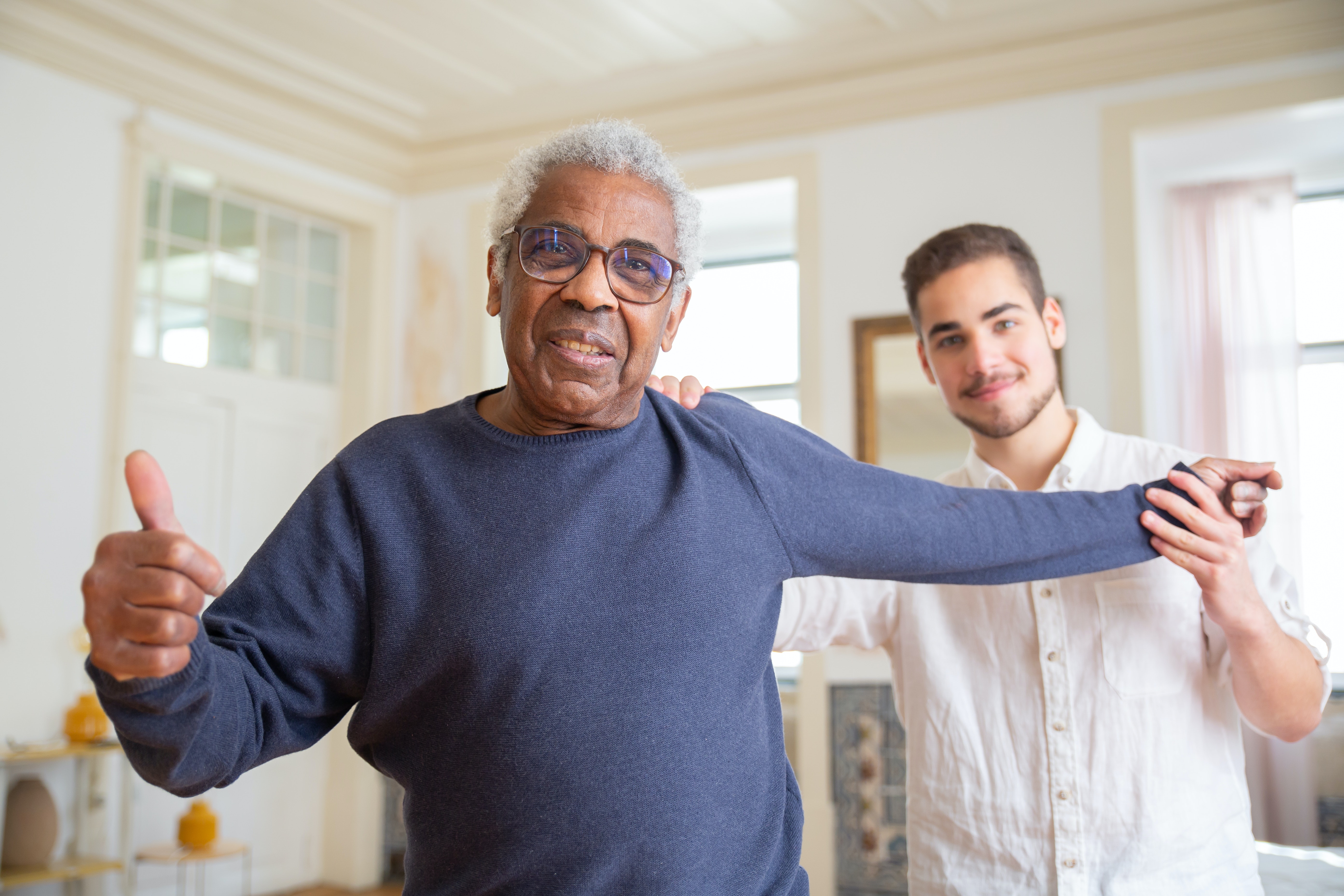 a nurse holding an elderly woman's hand